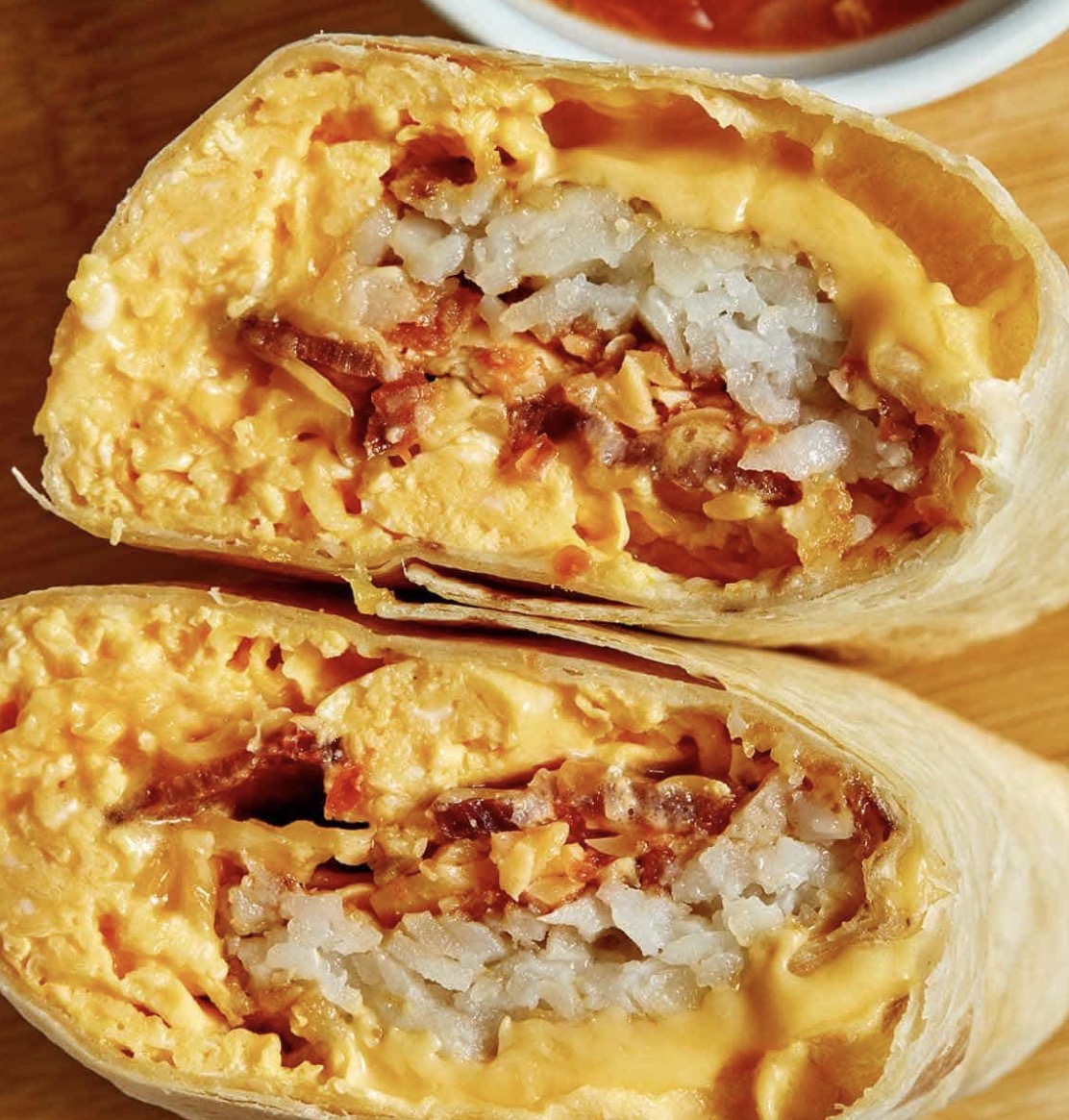 Breakfast burrito with egg, cheese, peppers and onions