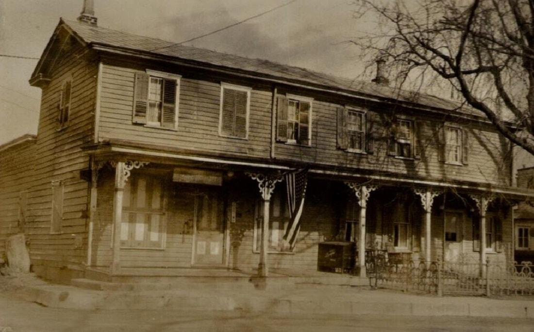The Edinburg general store in its early years, with wraparound porch and American flag